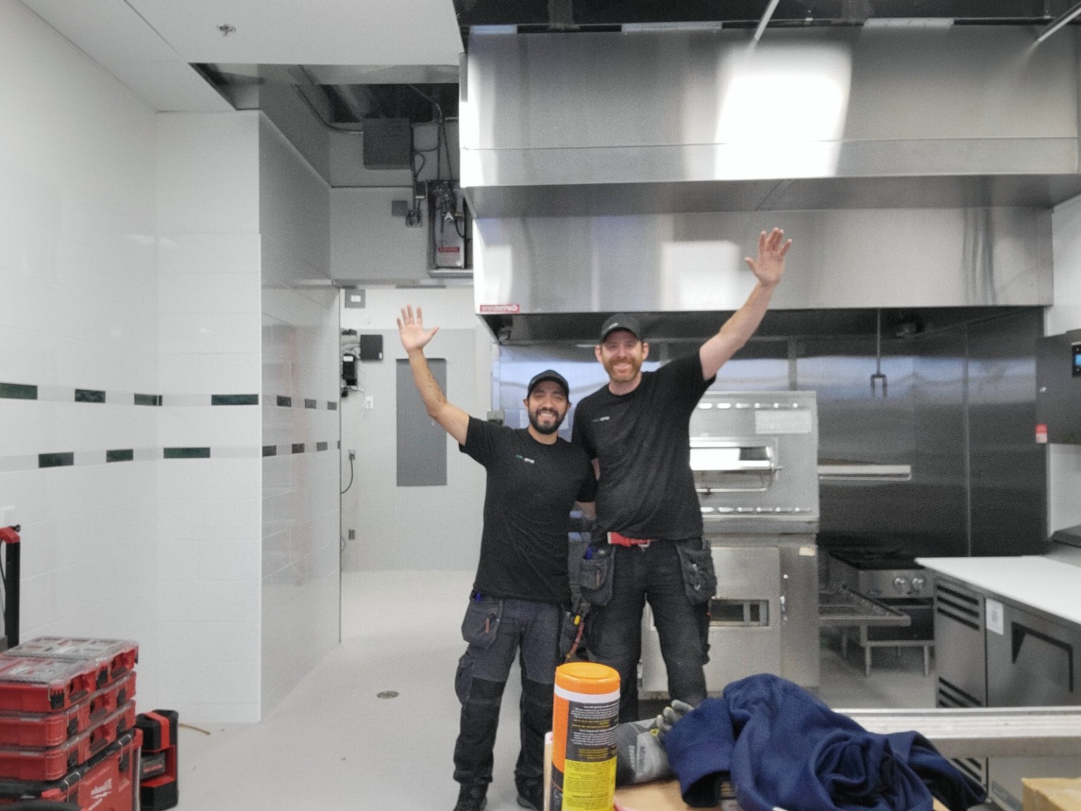 Two members of the Optus Power team on a commercial kitchen job